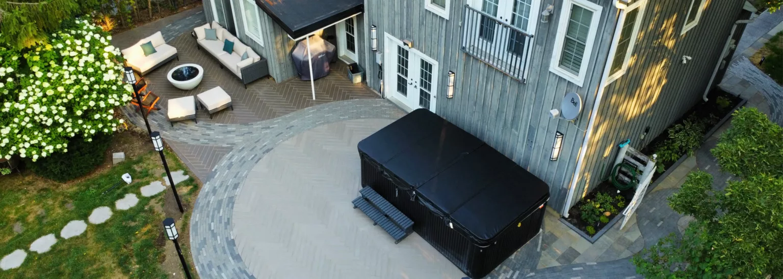 Aerial view of curved flagstone walkway and swim spa patio at heritage home in Nashville, Ontario landscaped by NRX Landscaping