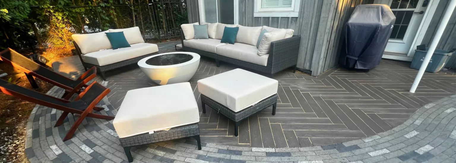 Modern patio seating area with Techo Bloc Borealis herringbone pavers, fire pit, and curved walkway in Nashville, Ontario backyard