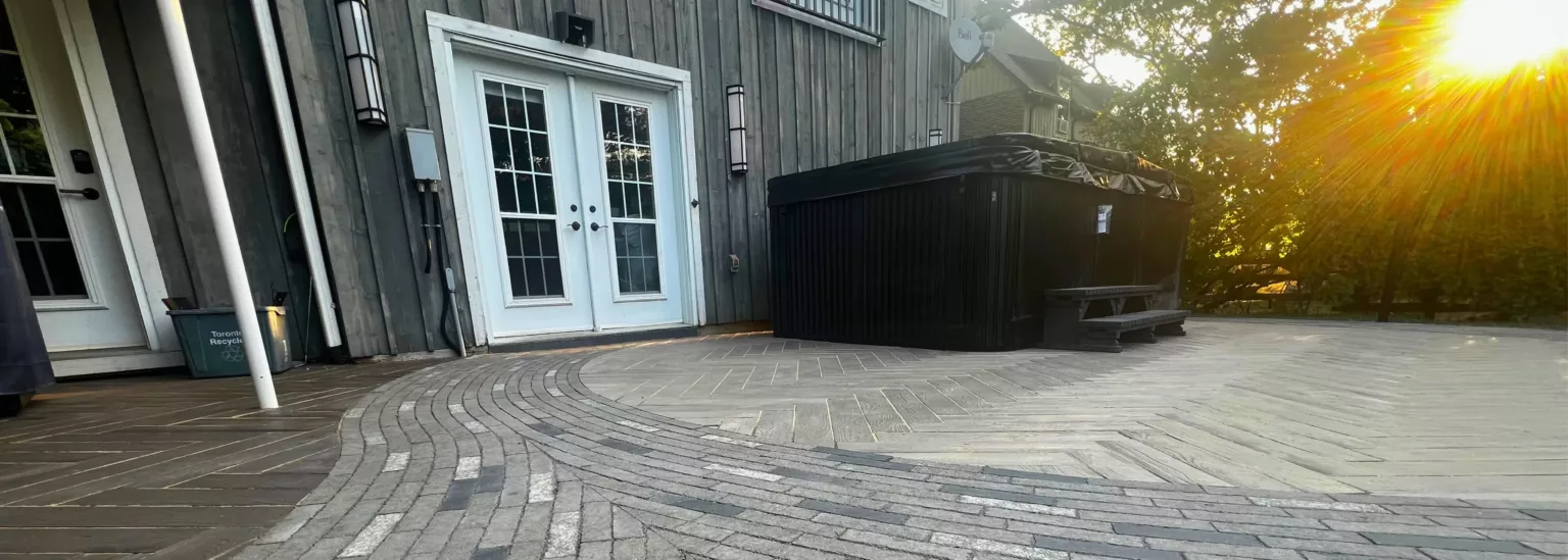Swim spa patio with curved flagstone walkway and herringbone Borealis pavers at heritage property in Nashville, Ontario